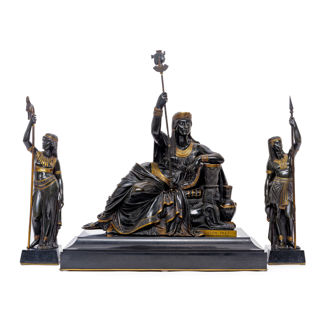 French bronze sculpture of Cleopatra with guards, highlighting regal Egyptian history