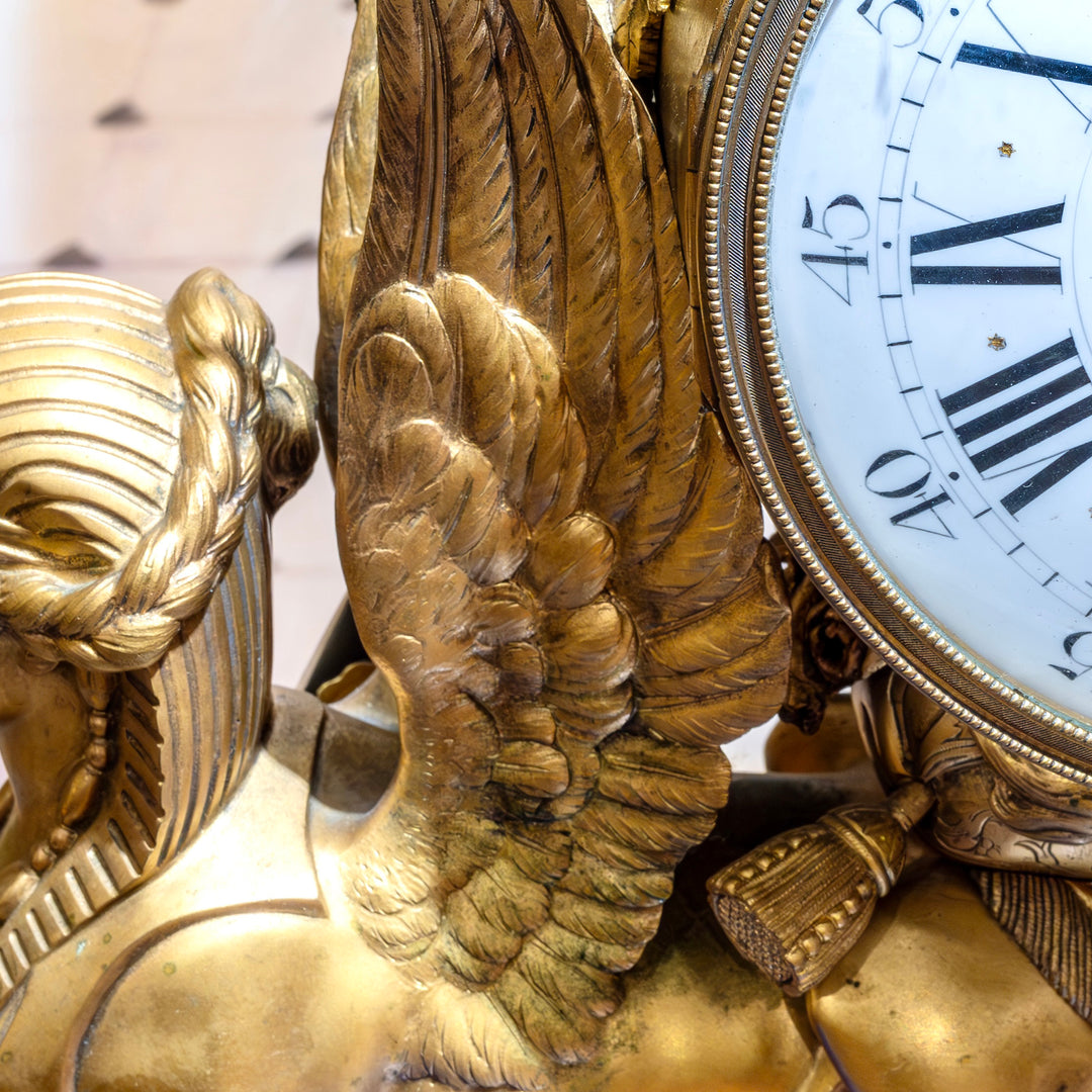 Bronzed winged figures atop a Lapis Lazuli base