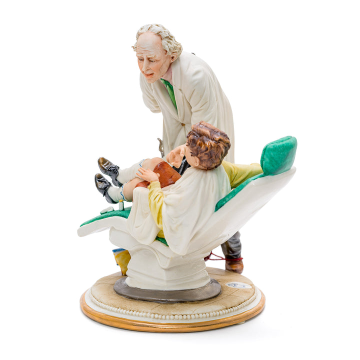 Italian crafted scene of a dentist with a child in porcelain.