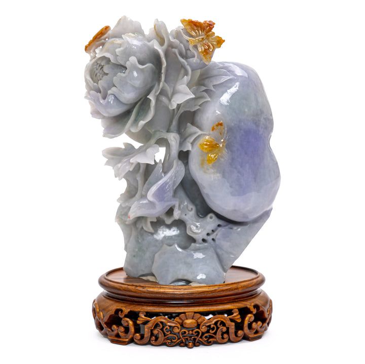 Lavender jade lotus flower against a jade boulder.