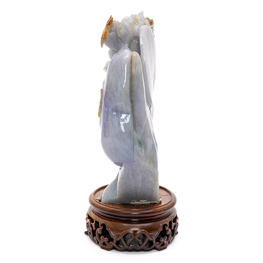 Serene lotus sculpture with carved birds and butterflies.