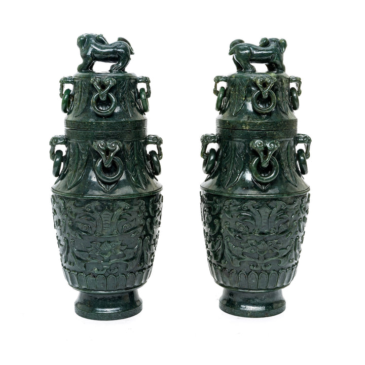 Deep green jade vases with lustrous finish and cultural symbols.