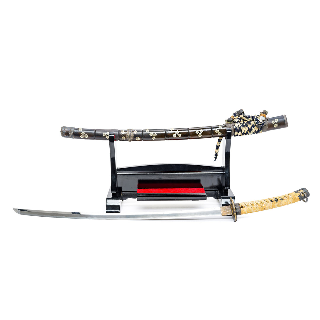 Handle wrapped in black and white diamond-patterned cord