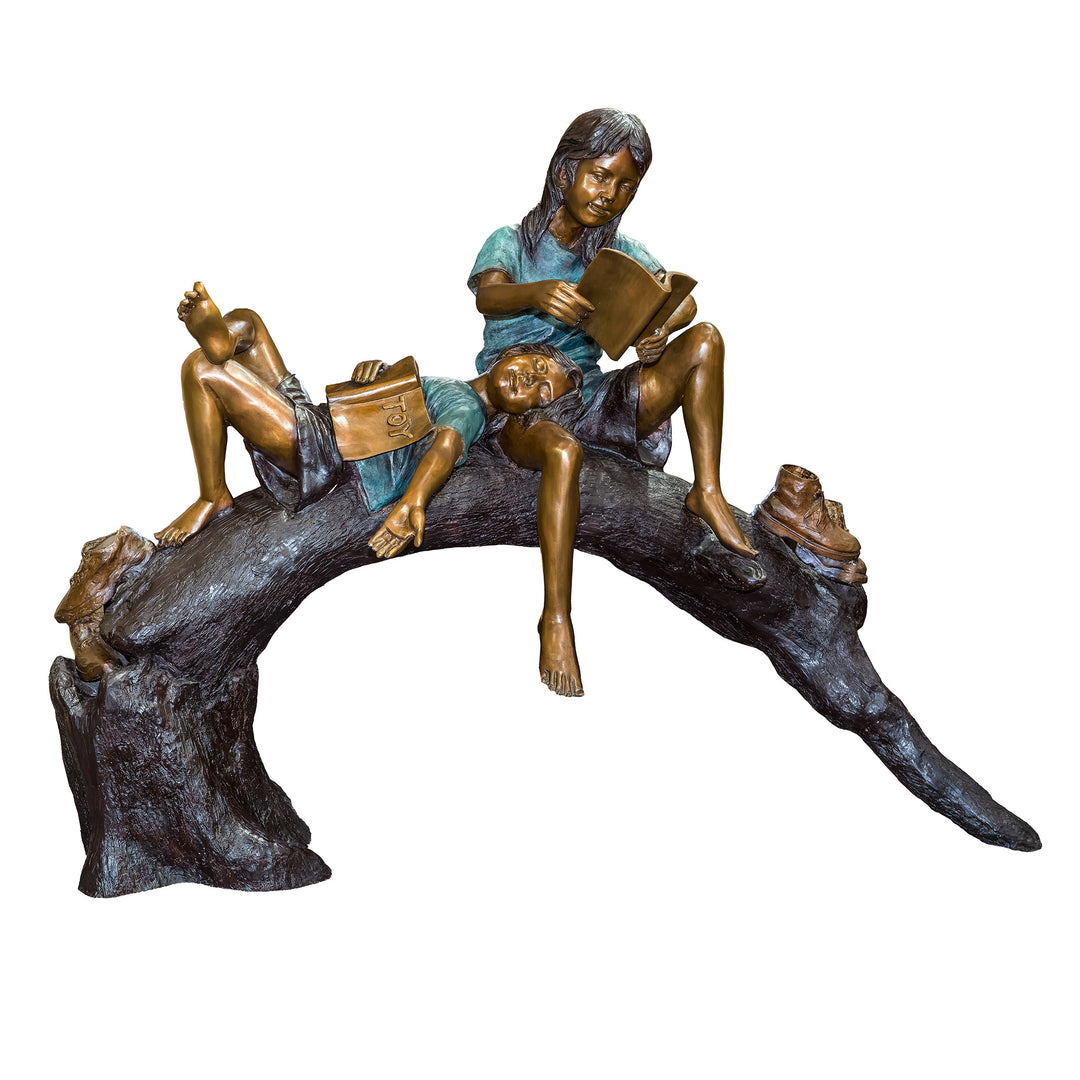 Bronze children reading on a log sculpture
