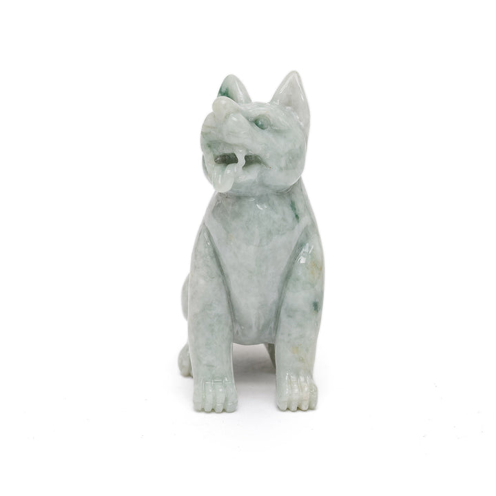 Carved jade dog figurine with protective stance