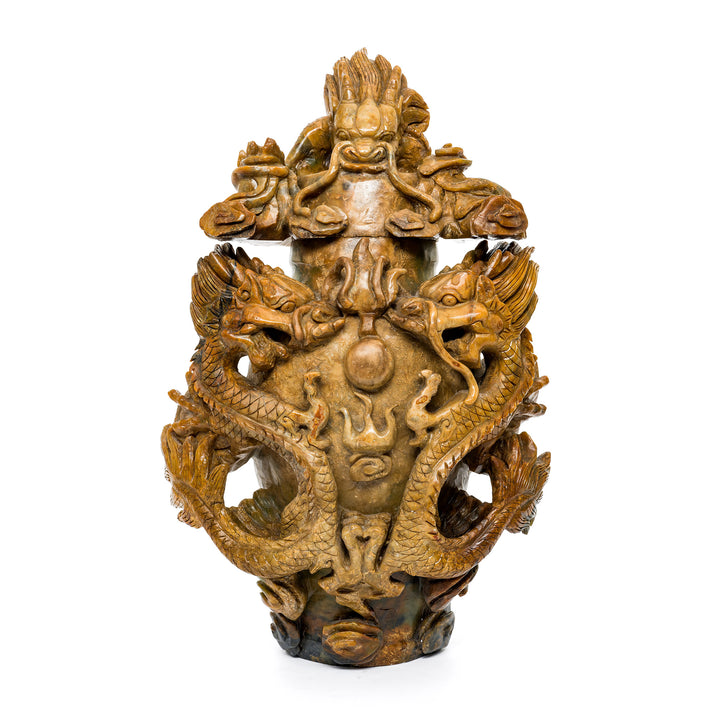 Hand-carved stone dragon sculpture with intricate detailing.