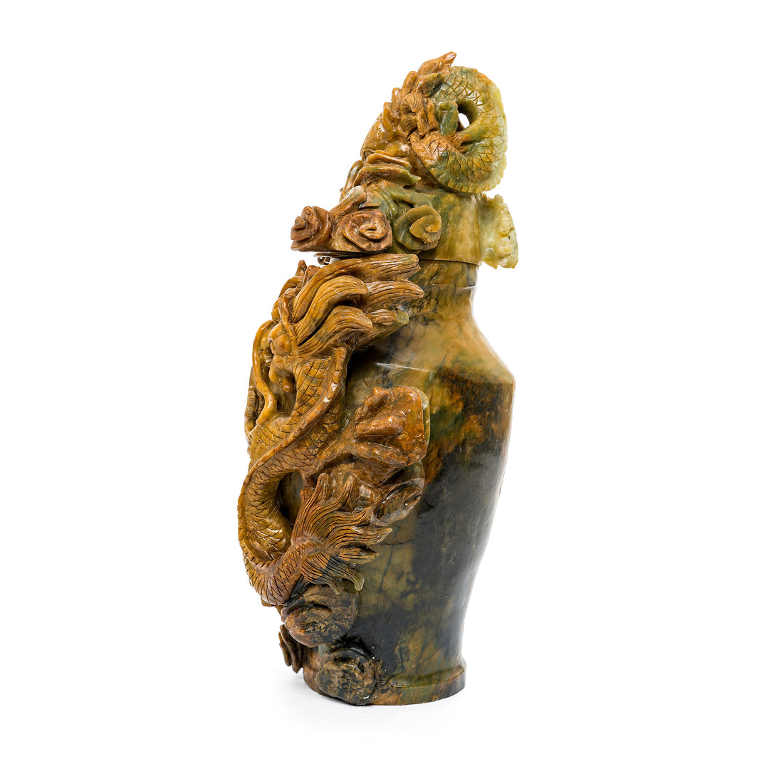 Intricate dragon stone art sculpture with central orb design.