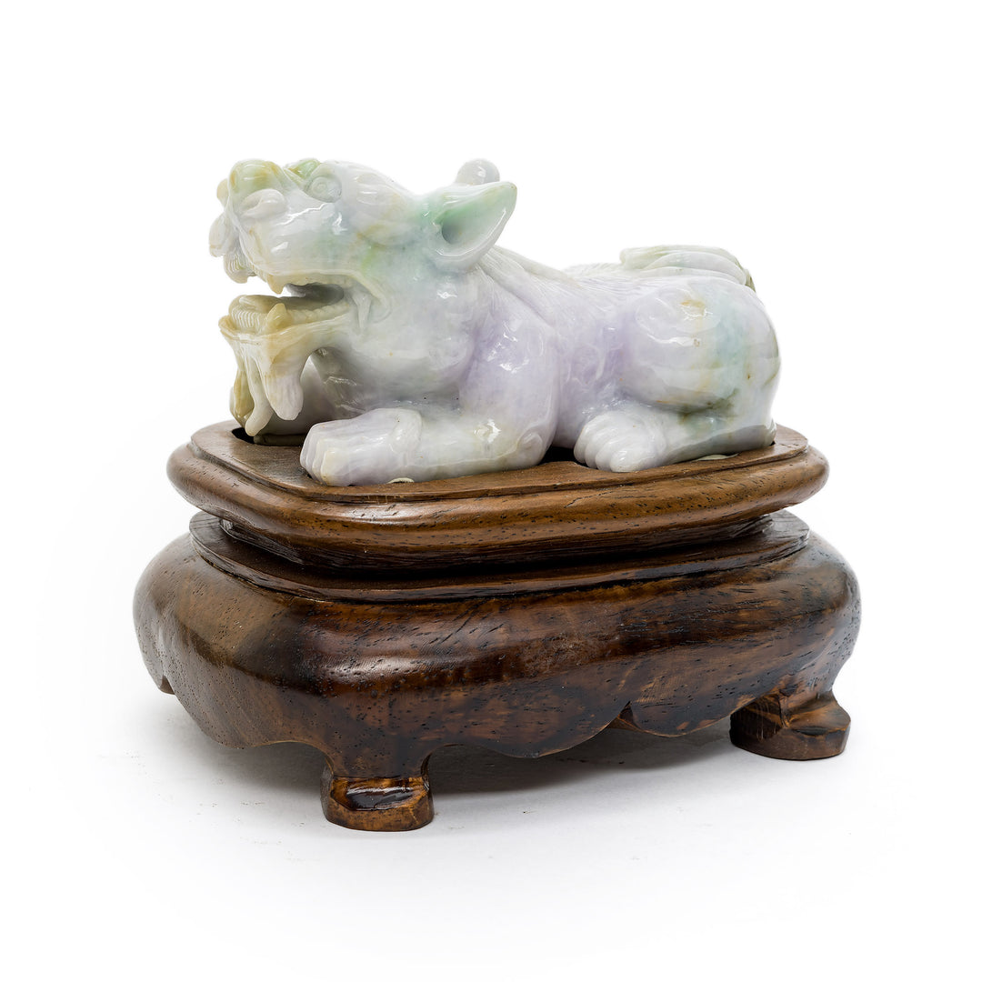 Side view of pale green jade Fu Dog statue on dark wood base
