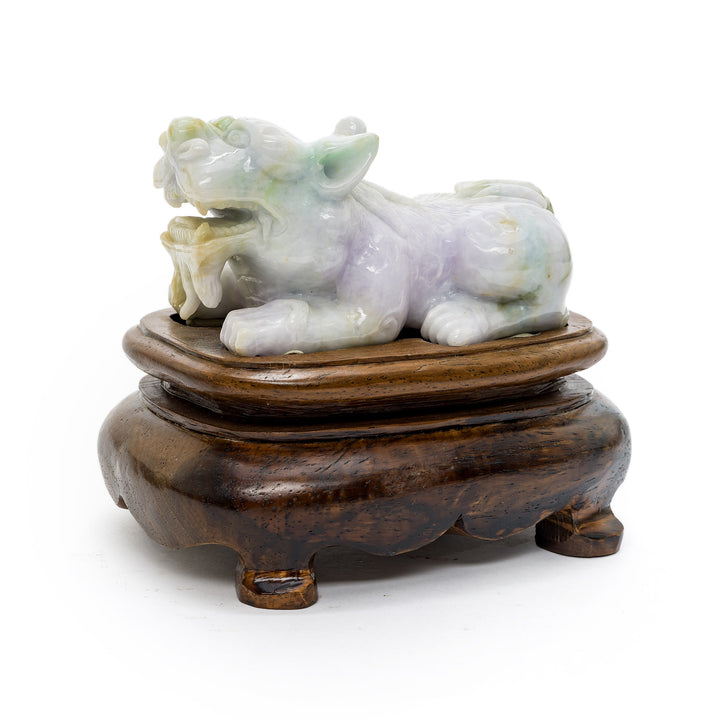 Side view of pale green jade Fu Dog statue on dark wood base