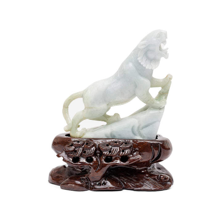 Jade tiger sculpture standing on ledge roaring