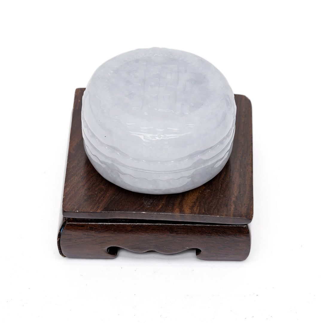 Side view of jade trinket box on wood stand