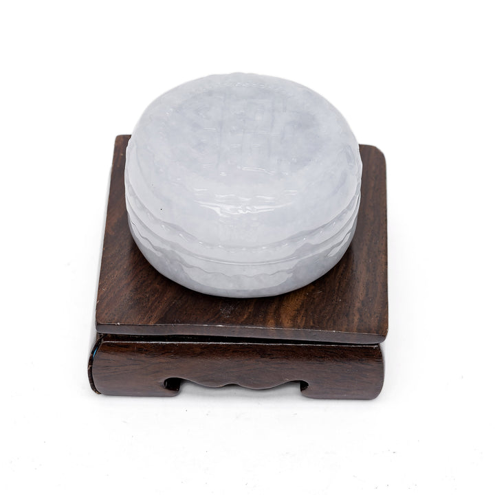 Side view of jade trinket box on wood stand