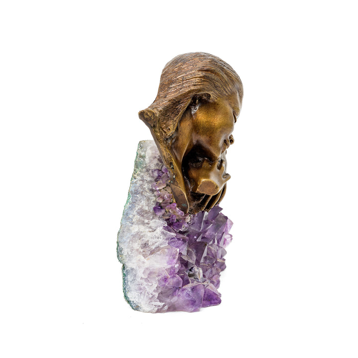 Soft lighting detail showing amethyst base under resting figure
