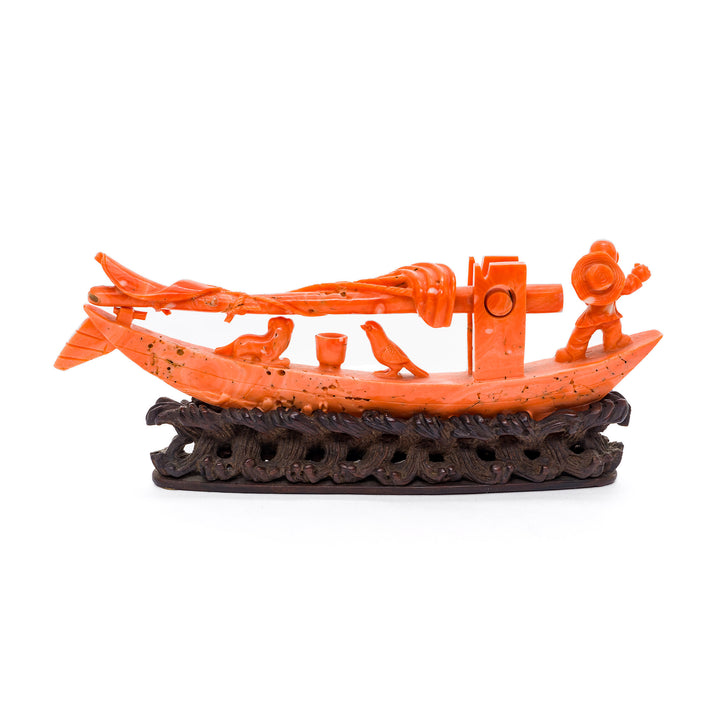 Miniature Chinese sailing boat in coral