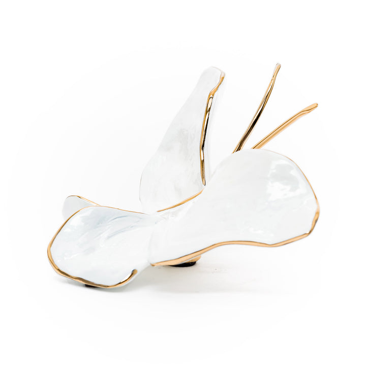 Side angle showing glossy pearl butterfly with golden accents