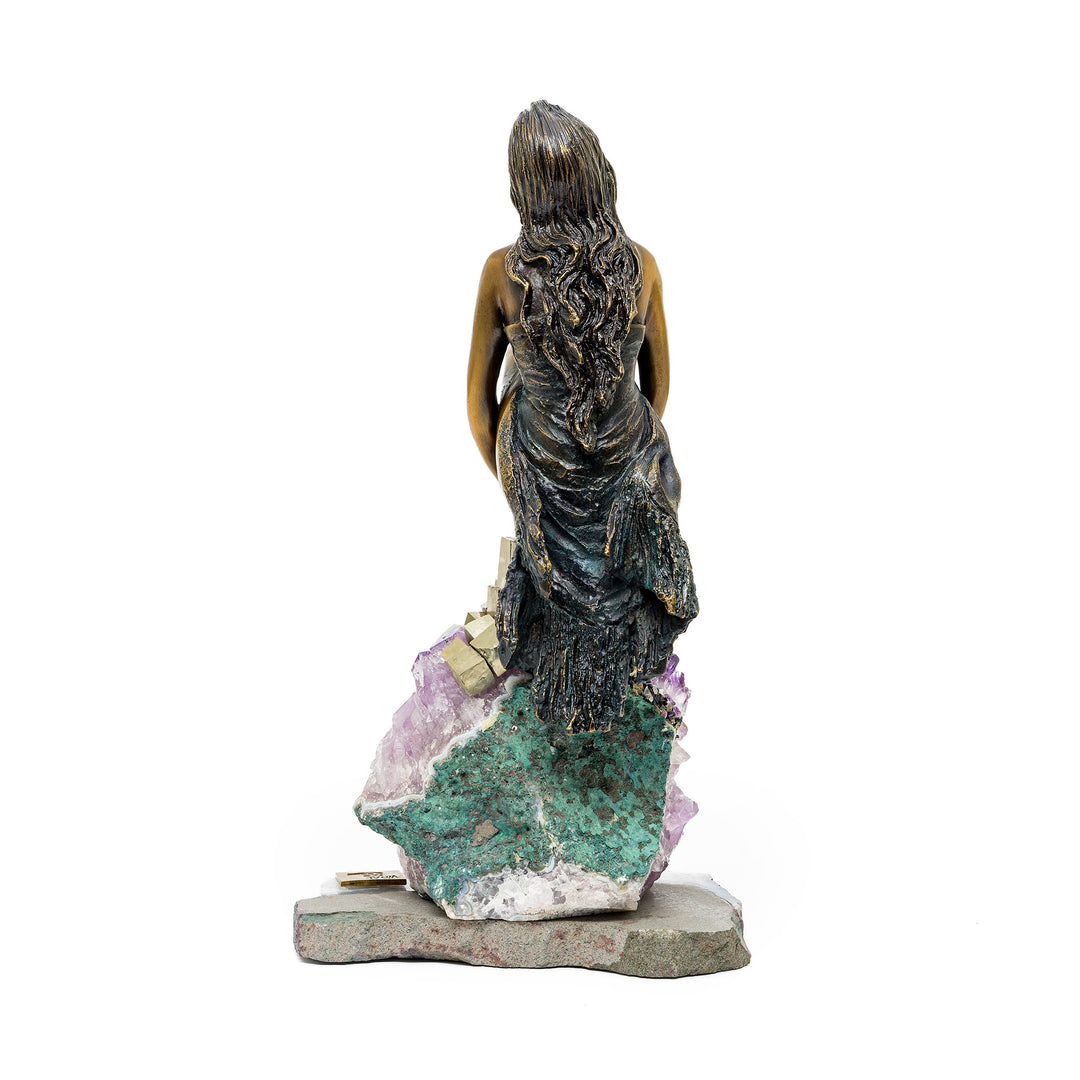 Rear view of bronze figure with detailed textured dress and hair
