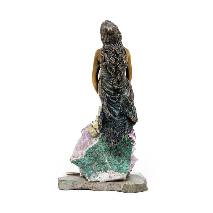 Rear view of bronze figure with detailed textured dress and hair