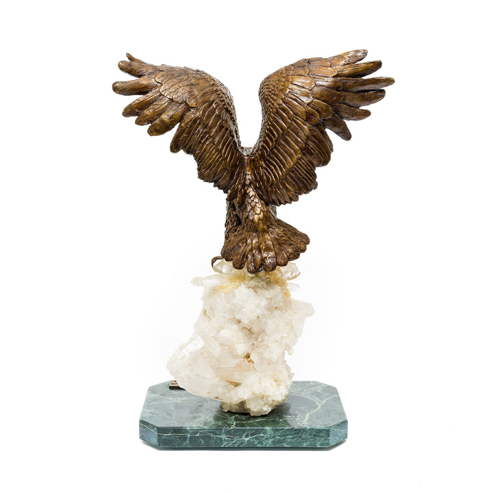 Rear view of detailed bronze eagle perched on quartz