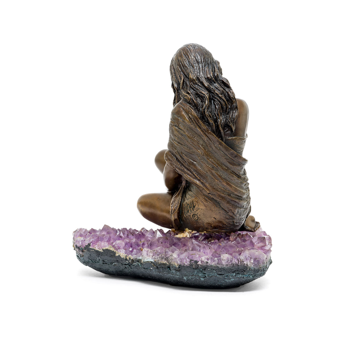 Rear view showing flowing hair and draped garment in bronze