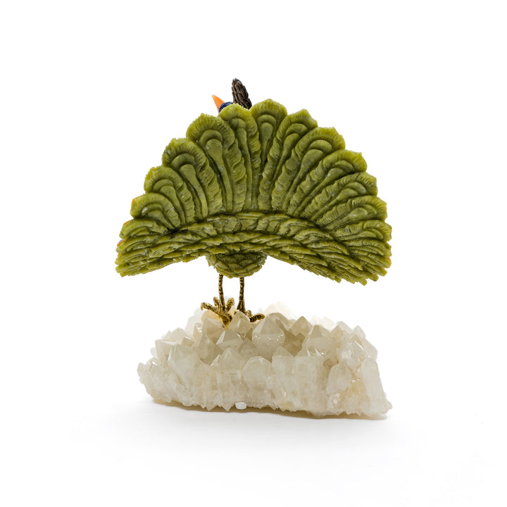 Rear view of fan-spread peacock standing on white quartz cluster
