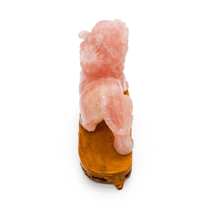 Backside of rose quartz lion highlighting tail and texture