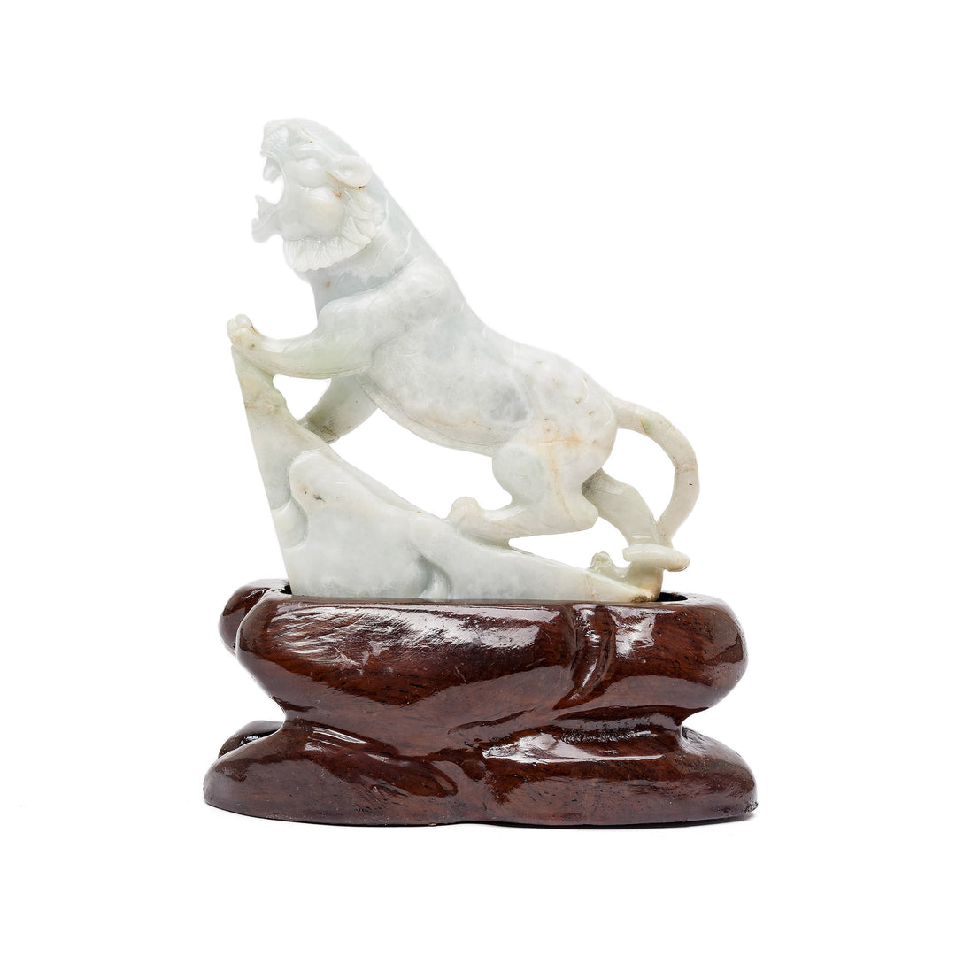 Rear view of roaring jade tiger on wood base
