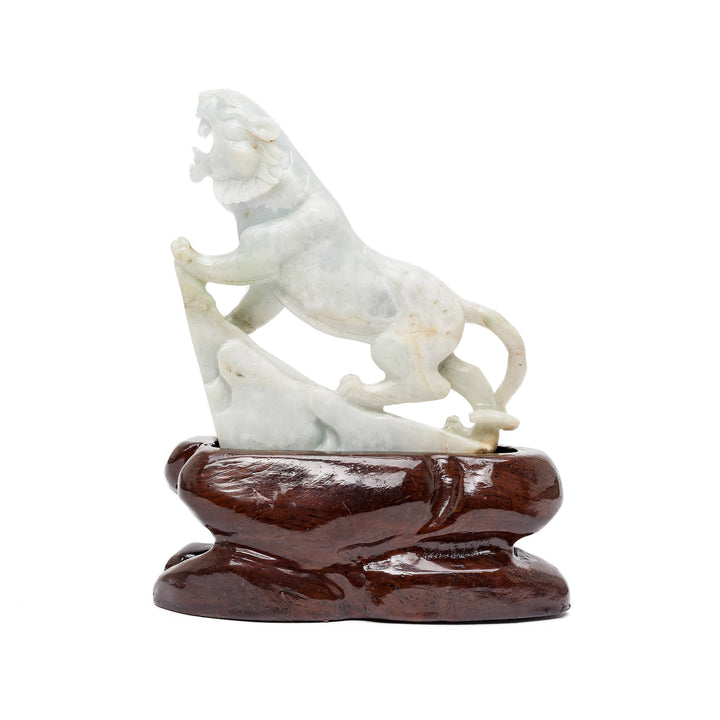 Rear view of roaring jade tiger on wood base