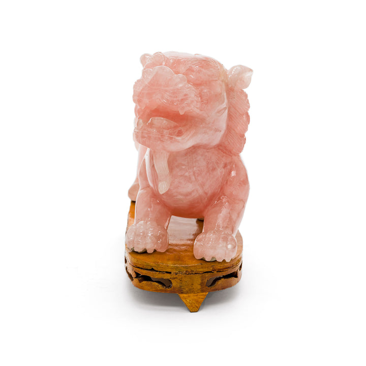 Front-facing view of detailed rose quartz guardian lion sculpture