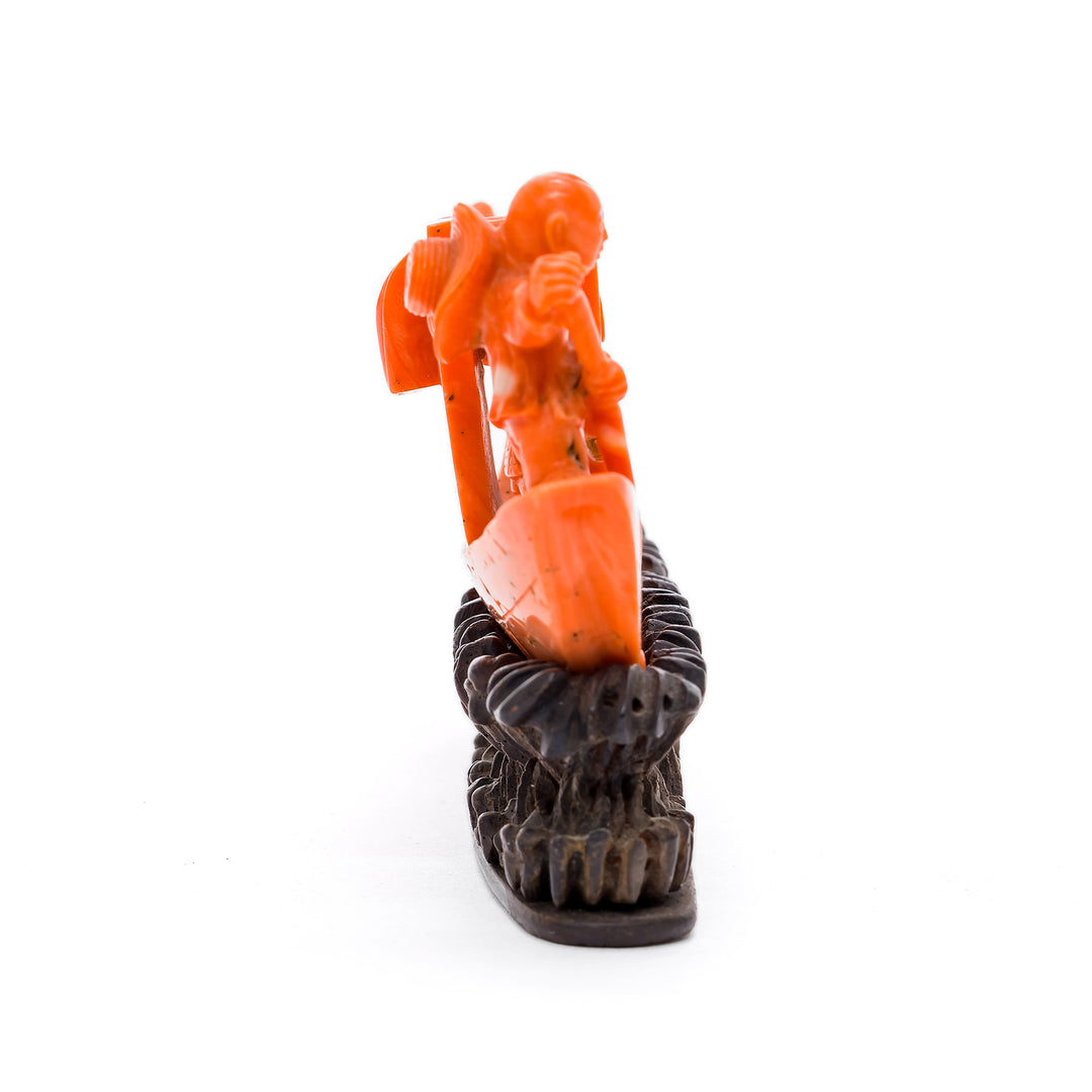Side view of detailed coral boat carving