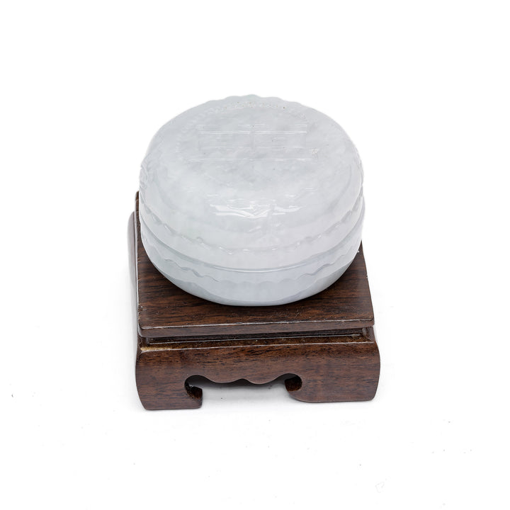 Small round jade box with polished wood base
