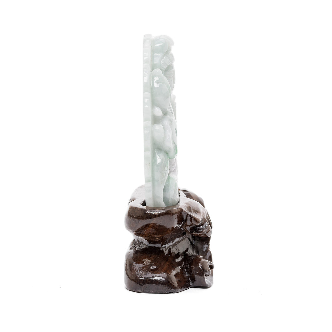 Spiritual jade carving on wood base