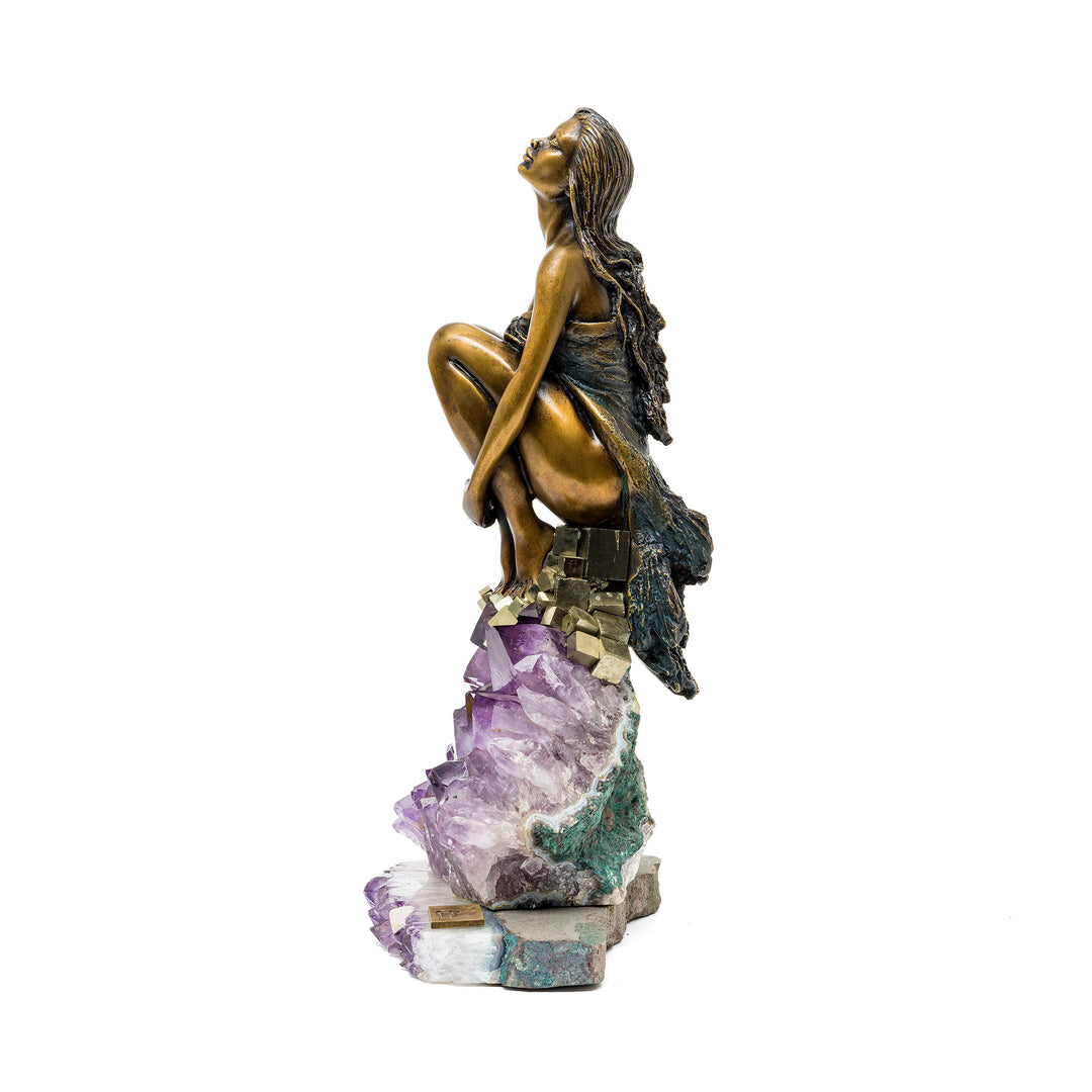 Side angle showing woman’s upward gaze and layered mineral base