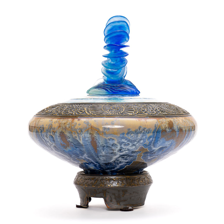 Artistic vase with bronze accents and sparkling blue crystal design