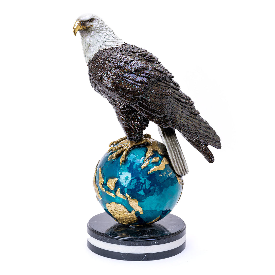High-gloss painted eagle on bronze globe sculpture