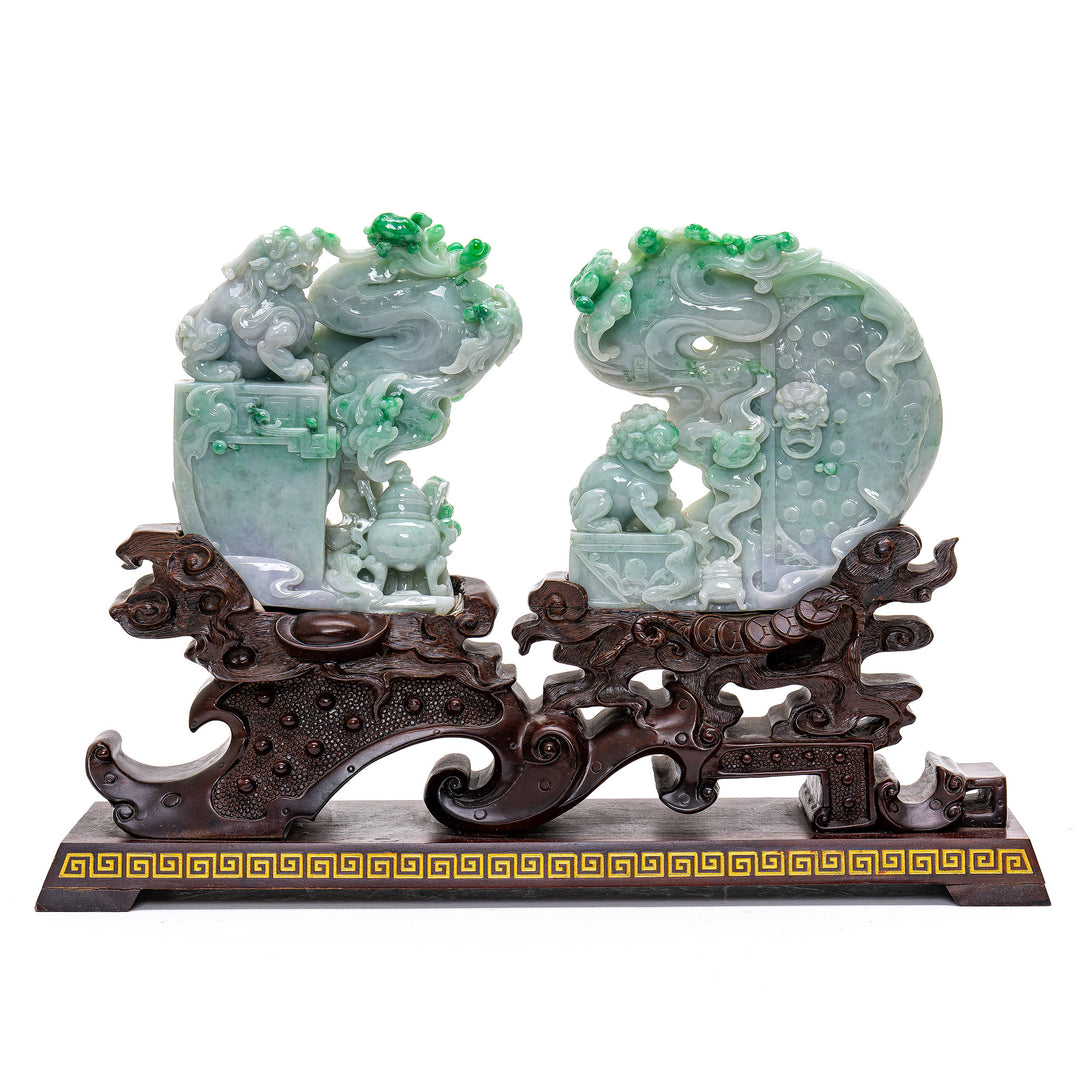 Majestic jade Fu Lion sculptures on ornate mahogany bases.