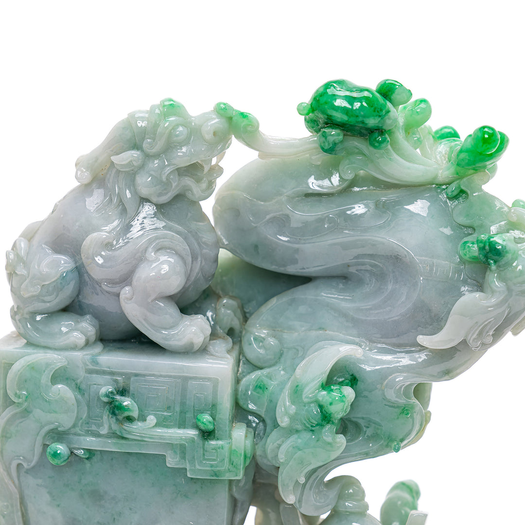 Traditional Chinese Fu Lions in varied jade hues with emerald accents.