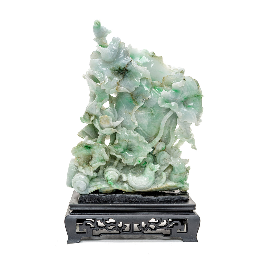 Elegant jadeite sculpture with lush vine details and birds.