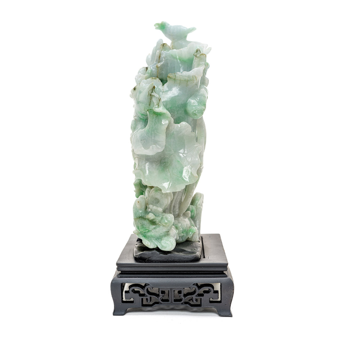 Artisan-crafted jadeite planter pot with blooming flora.