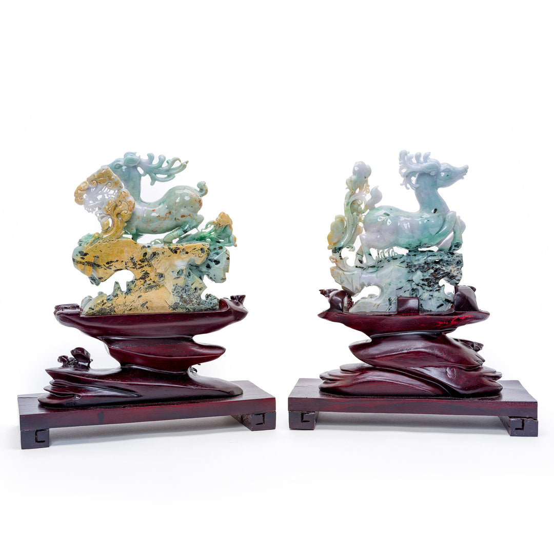 Nature's majesty captured in a pair of jade reindeer statues amidst foliage