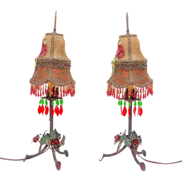 Matching antique lamps with handcrafted embroidery and sculpted roses.