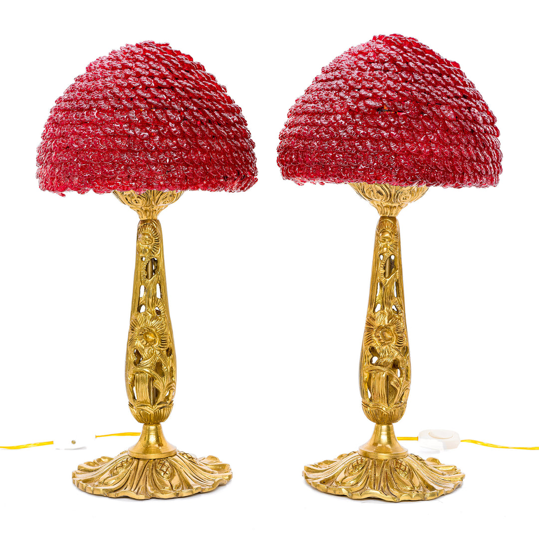 Pair of red crystal table lamps with dore bronze foliate bases.