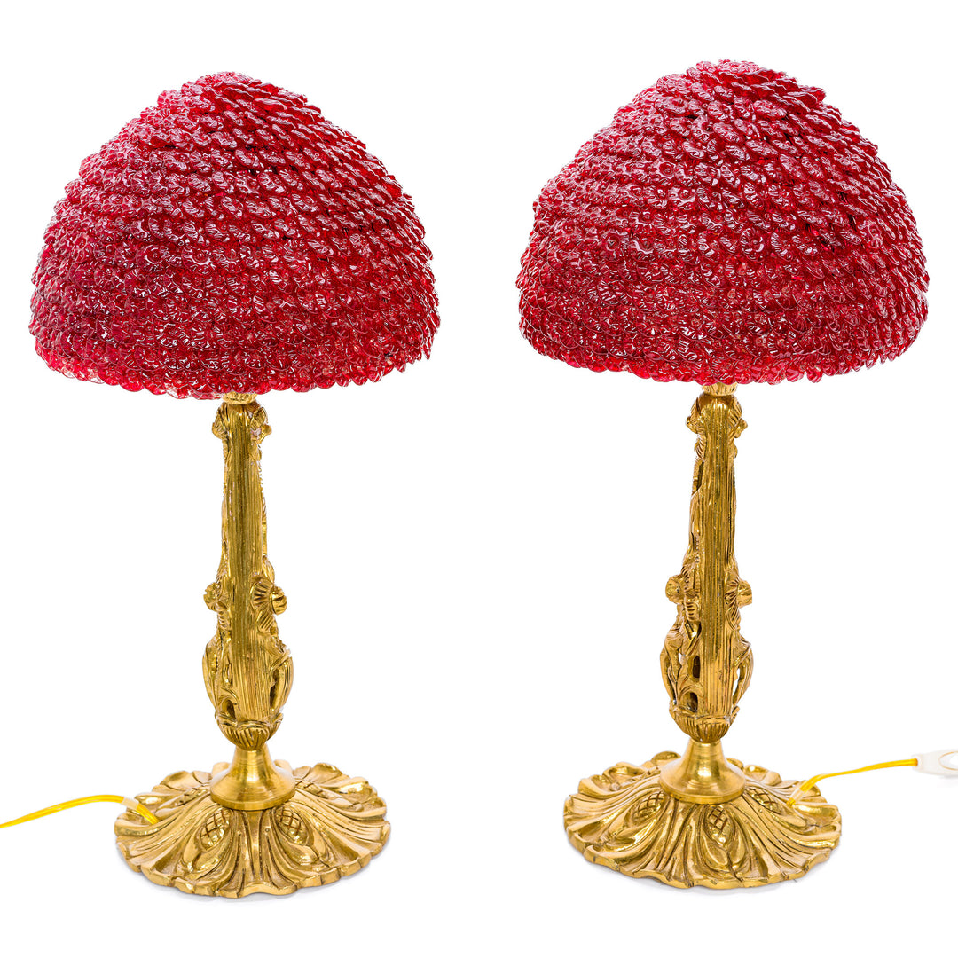 Elegant table lamp duo featuring red crystal shades and intricate bronze work.