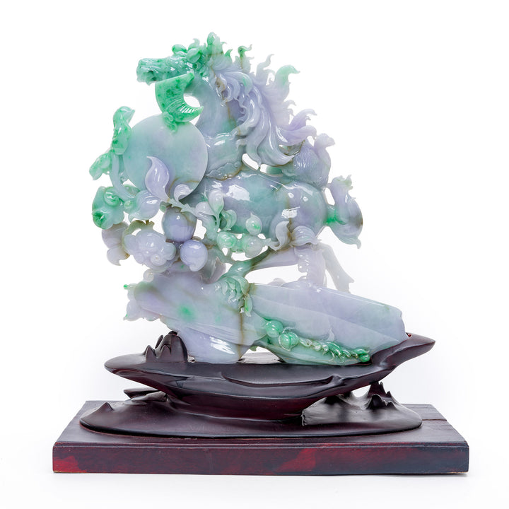 Dynamic carved jade horse running amidst peach gourds, a symbol of longevity