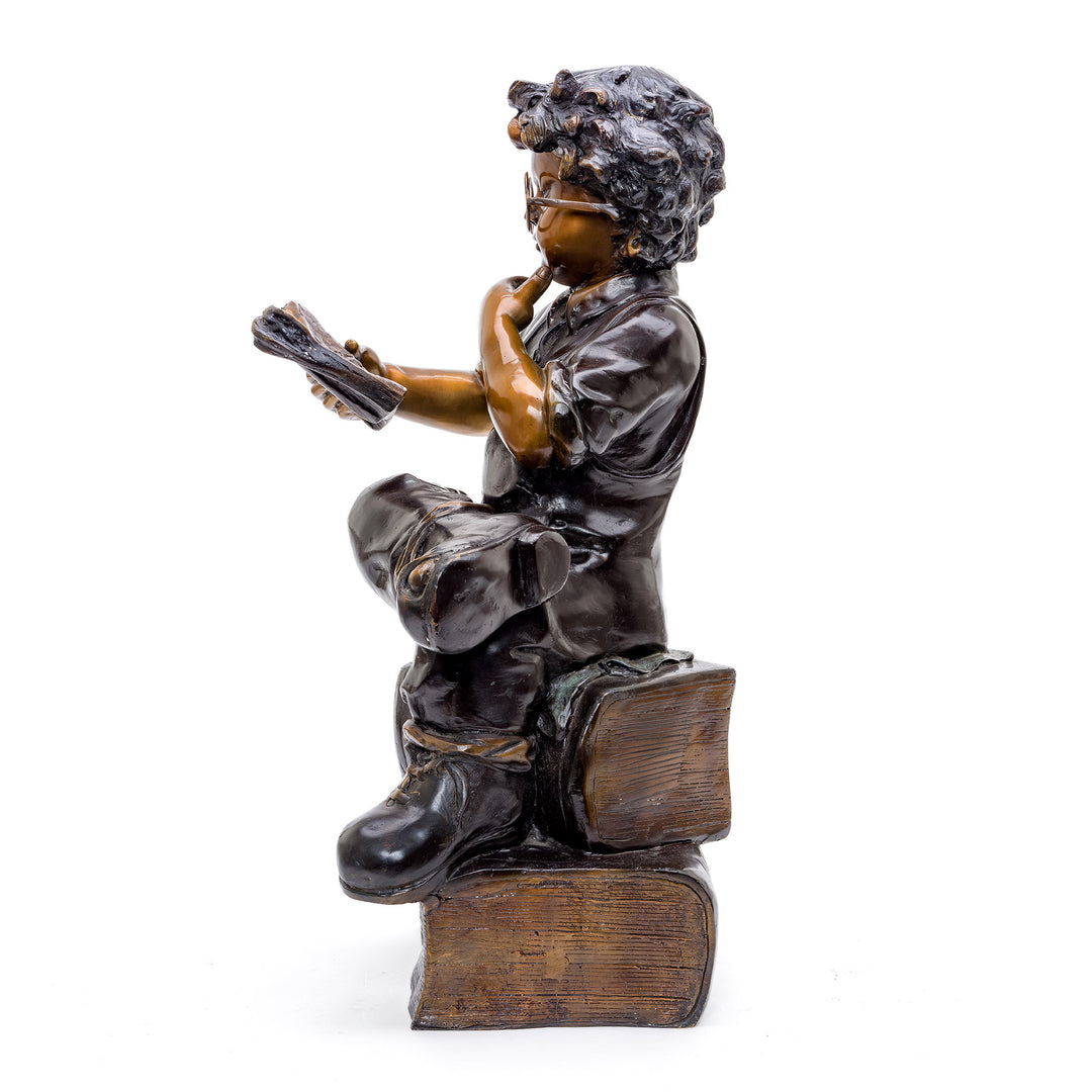 Detailed Statue of Young Boy Engrossed in Reading.