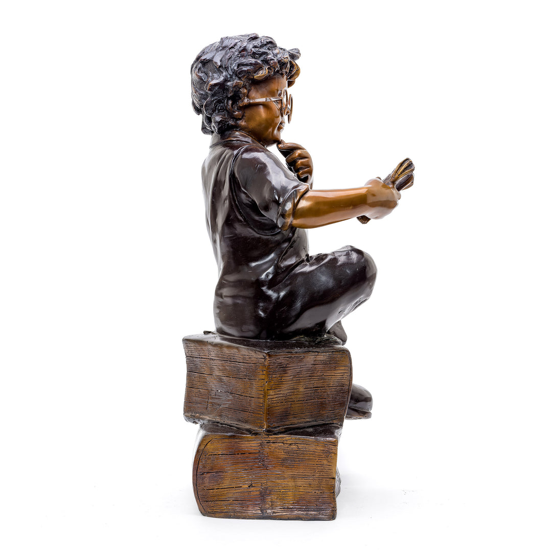 Artistic Representation of Boy and His Books in Bronze.