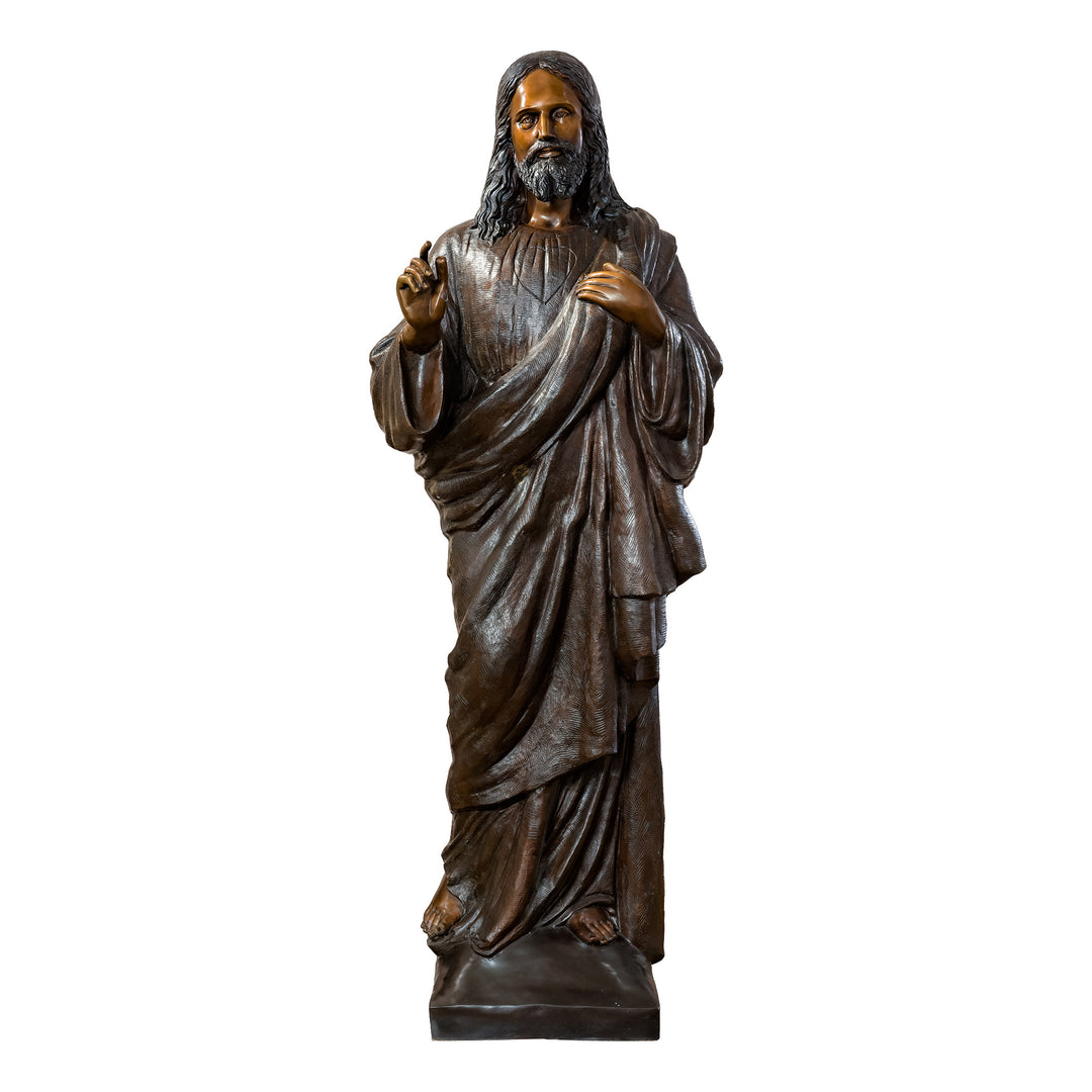 Majestic bronze sculpture of Jesus with open hands.