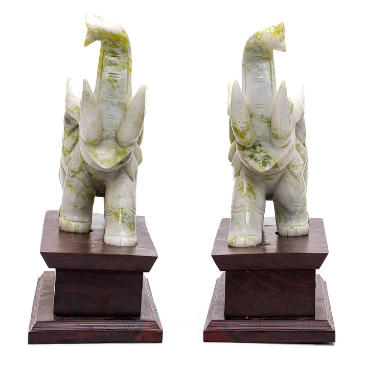 Decorative mirror image elephant sculptures with marbled green detailing.