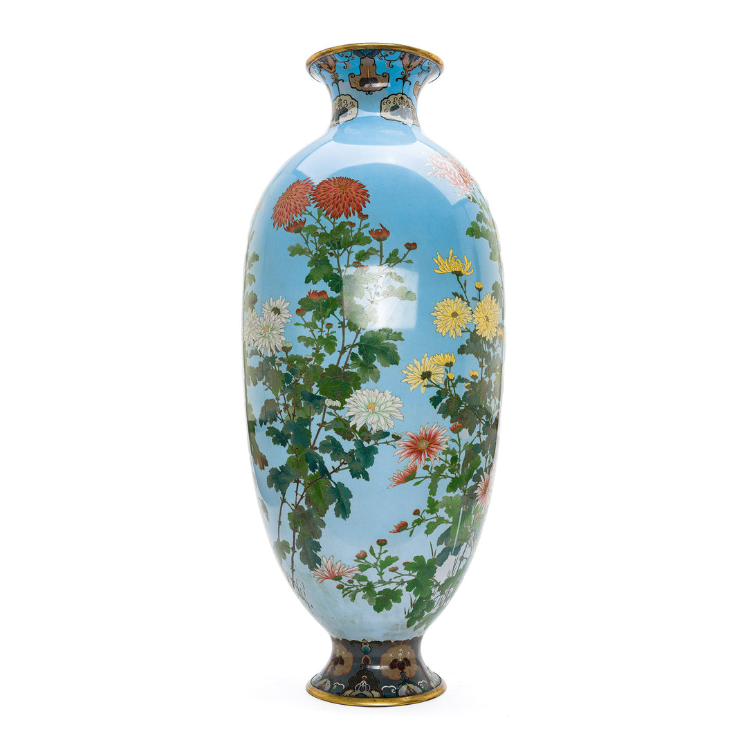 Light blue Cloisonné vase with gold trim and lush garden scene