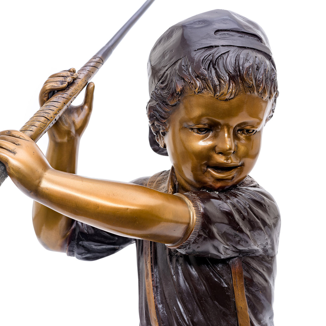 Bronze golfing statue with detailed boy in swing pose