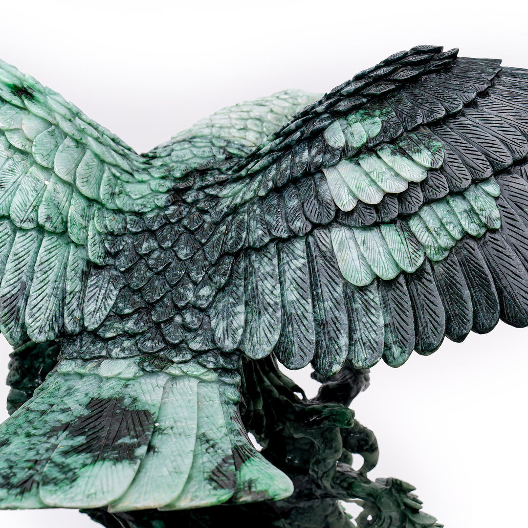 Detail-rich carved jade depiction of an eagle in flight, symbol of resilience